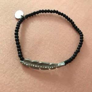 Black beaded bracelet with feather design